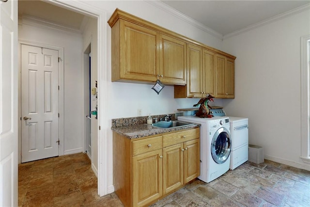 laundry area featuring cabinets, separate washer and dryer, crown molding, and sink