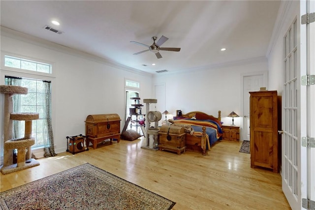 bedroom with french doors, light hardwood / wood-style floors, ceiling fan, and crown molding