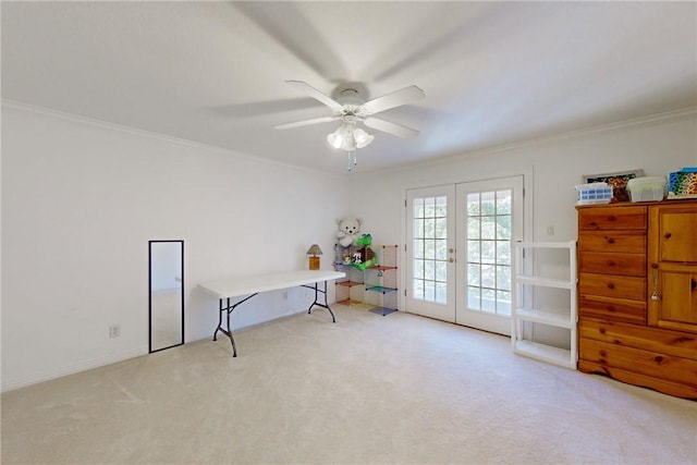 interior space with ceiling fan, ornamental molding, light carpet, and french doors