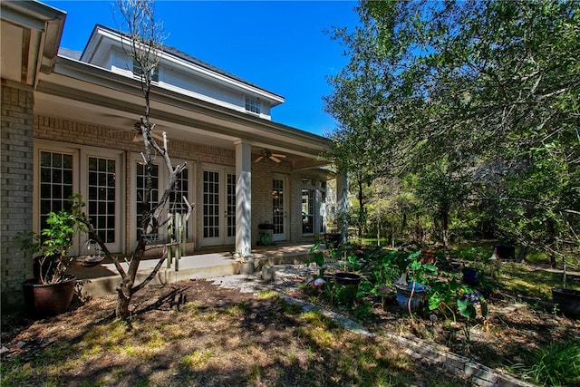 rear view of house with ceiling fan and french doors