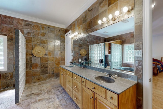 bathroom with vanity, crown molding, and tile walls