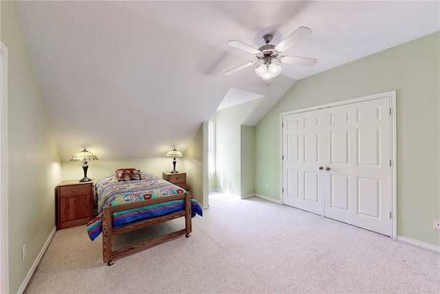 carpeted bedroom featuring a closet, ceiling fan, and lofted ceiling