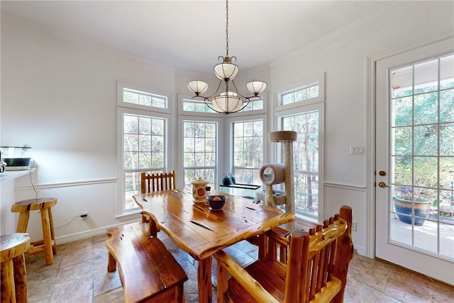 dining room with a chandelier and crown molding