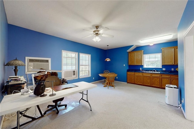 carpeted office space with a wall mounted air conditioner, ceiling fan, cooling unit, and sink