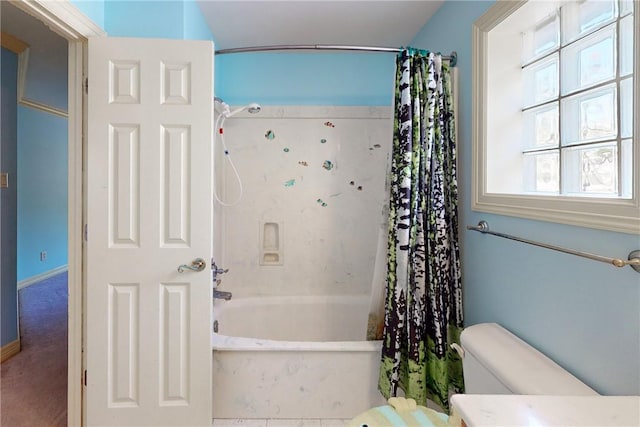 bathroom featuring toilet and shower / bath combo with shower curtain