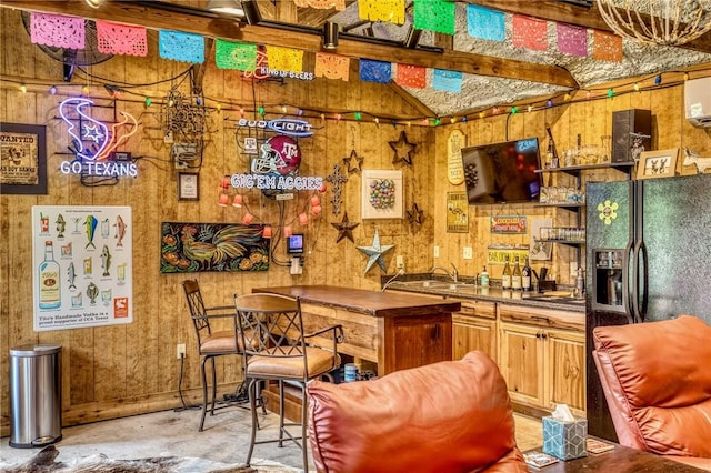 402 Ross St, Brenham, TX 77833 - bar with black refrigerator with ice dispenser, concrete flooring, wood walls, and a sink