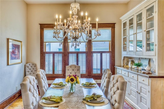 402 Ross St, Brenham, TX 77833 - dining room with a chandelier, baseboards, and wood finished floors