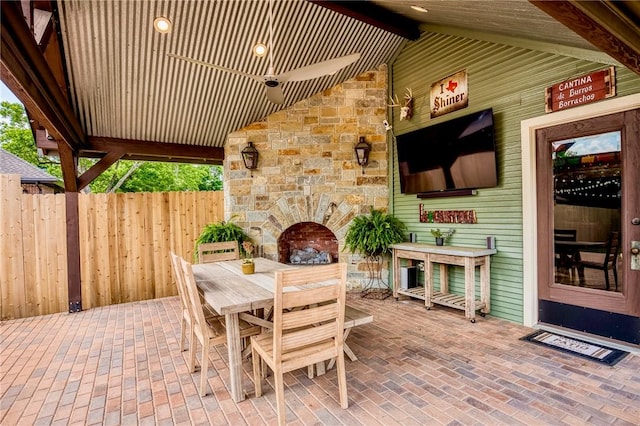 402 Ross St, Brenham, TX 77833 - view of patio / terrace featuring outdoor dining area and an outdoor stone fireplace