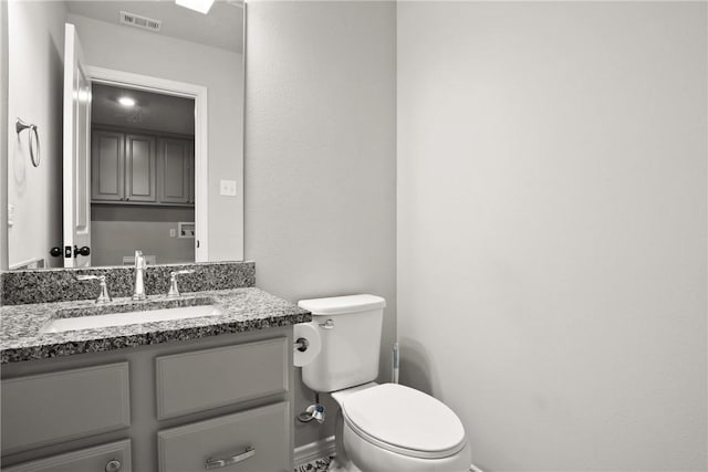 bathroom with toilet and vanity