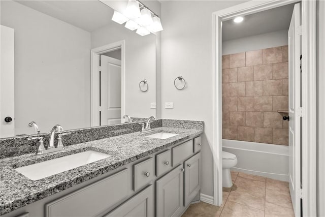 full bathroom featuring toilet, tiled shower / bath, tile patterned floors, and vanity