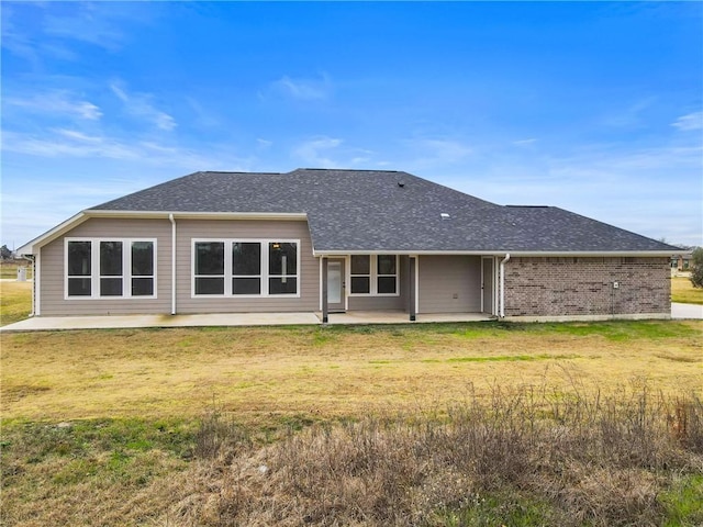 back of house featuring a patio area and a lawn