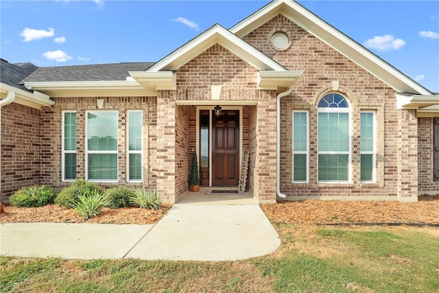 view of exterior entry with a yard