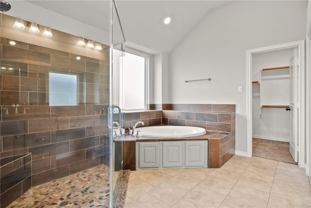 bathroom featuring lofted ceiling, tile patterned flooring, and separate shower and tub