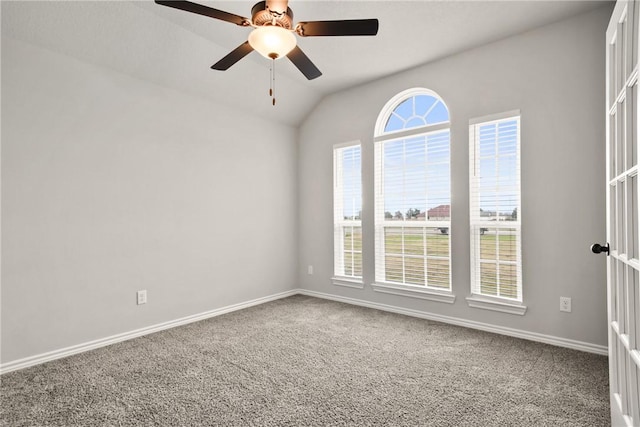 carpeted empty room with ceiling fan and vaulted ceiling