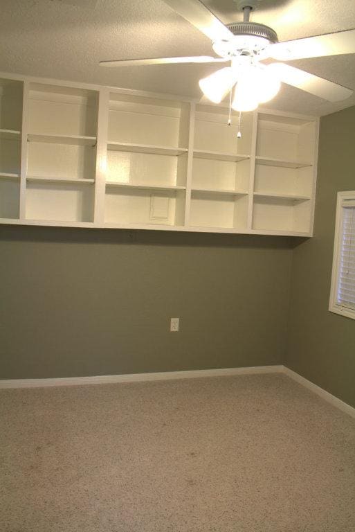 carpeted empty room with ceiling fan