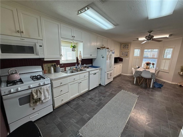 803 Welsh Ave, College Station, TX 77840 - kitchen with white appliances, a sink, light countertops, plenty of natural light, and a textured ceiling