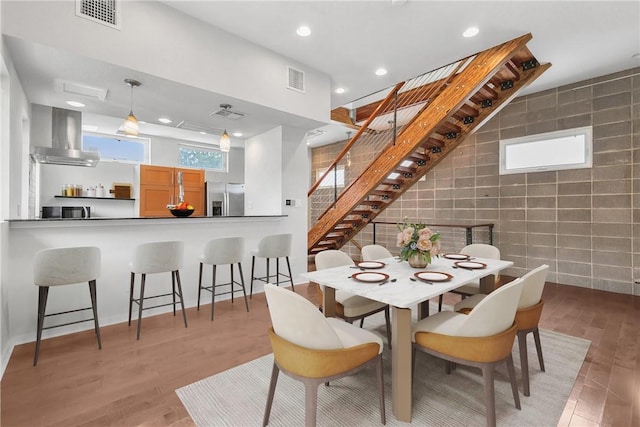 213 N Houston Ave, Bryan, TX 77803 - dining space with tile walls, recessed lighting, stairway, and light wood-style flooring