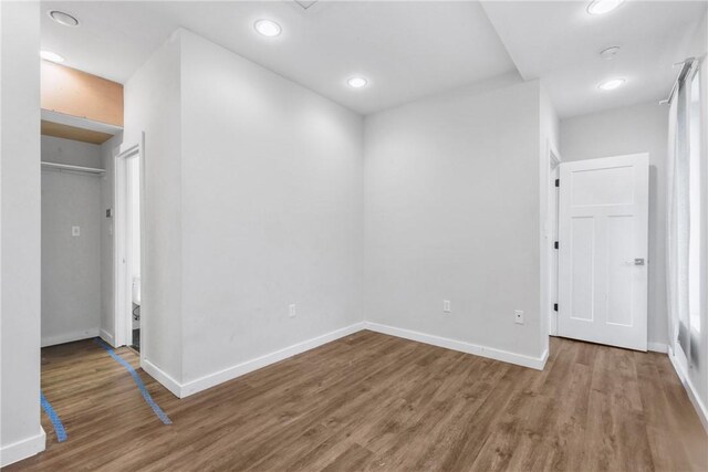 213 N Houston Ave, Bryan, TX 77803 - unfurnished bedroom with wood finished floors and recessed lighting