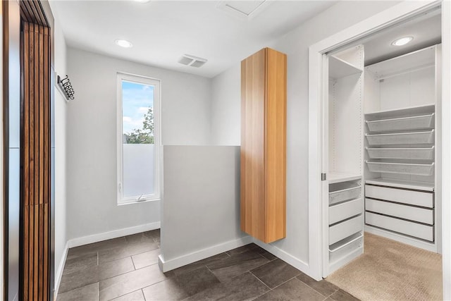 213 N Houston Ave, Bryan, TX 77803 - walk in closet with dark tile patterned flooring