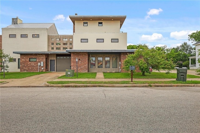 213 N Houston Ave, Bryan, TX 77803 - view of front of property featuring driveway, brick siding, and a garage