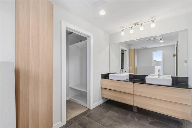 213 N Houston Ave, Bryan, TX 77803 - full bathroom featuring double vanity and baseboards