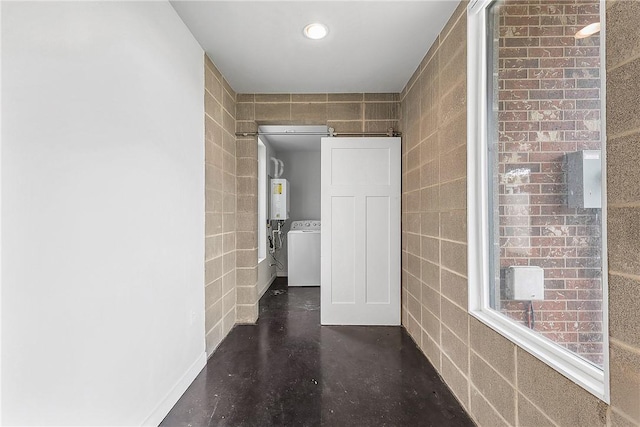 213 N Houston Ave, Bryan, TX 77803 - hallway featuring water heater, separate washer and dryer, tile walls, finished concrete floors, and recessed lighting