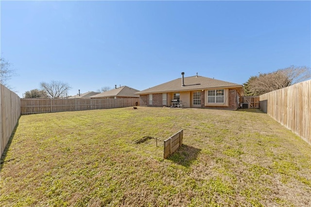 view of yard featuring a fenced backyard and central AC unit