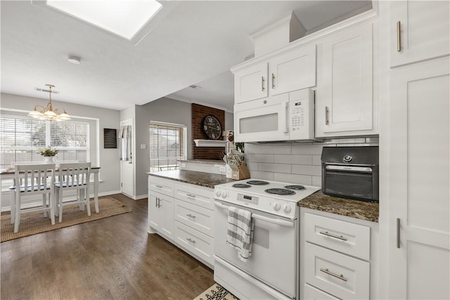 kitchen with white appliances, plenty of natural light, white cabinetry, and decorative backsplash