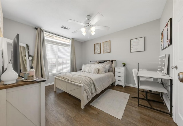 bedroom featuring baseboards, visible vents, and dark wood-type flooring