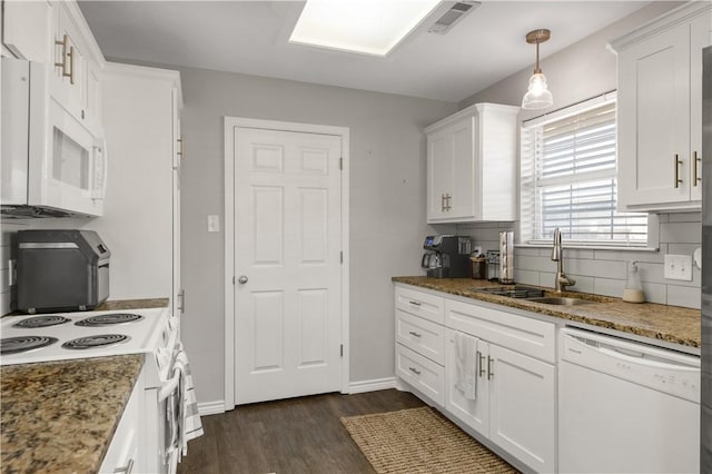 kitchen featuring dark wood finished floors, visible vents, white cabinets, a sink, and white appliances