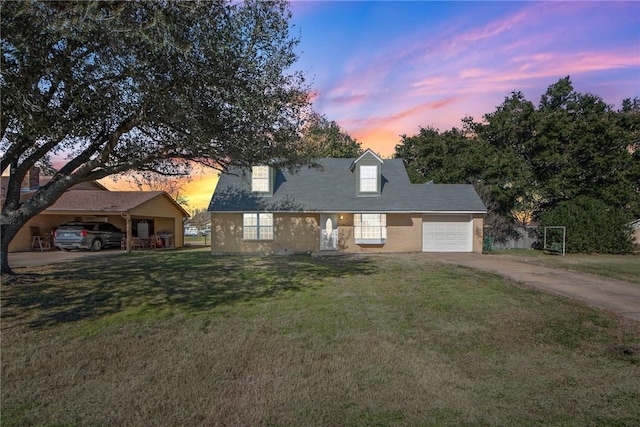 cape cod house with driveway, a lawn, and an attached garage