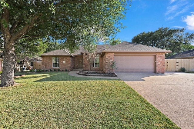 ranch-style house featuring a front yard and a garage