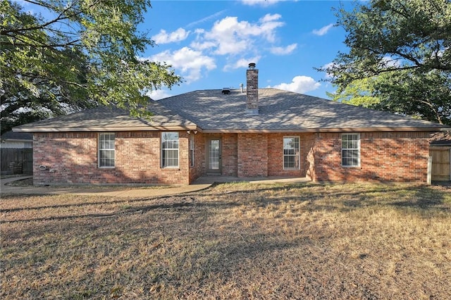 rear view of property with a yard