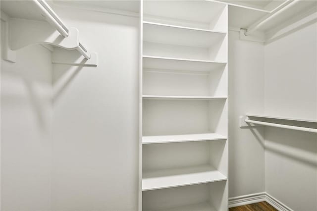 walk in closet featuring dark hardwood / wood-style flooring