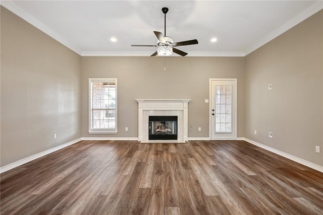 unfurnished living room with dark hardwood / wood-style flooring, ornamental molding, and a tile fireplace