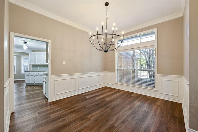 unfurnished dining area featuring a notable chandelier, dark hardwood / wood-style flooring, and crown molding