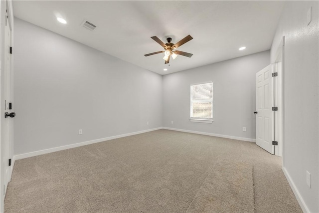 empty room with ceiling fan and light carpet