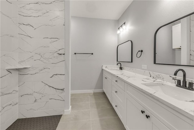 bathroom with tiled shower and vanity