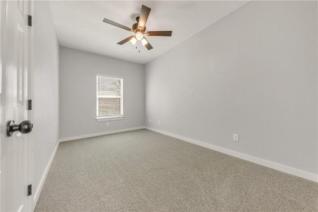 carpeted empty room featuring ceiling fan