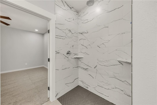 bathroom with tiled shower and ceiling fan