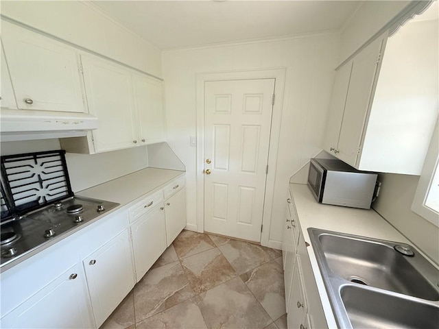 1223 Boswell St, College Station, TX 77840 - kitchen with stainless steel microwave, range hood, white cabinetry, crown molding, and light countertops