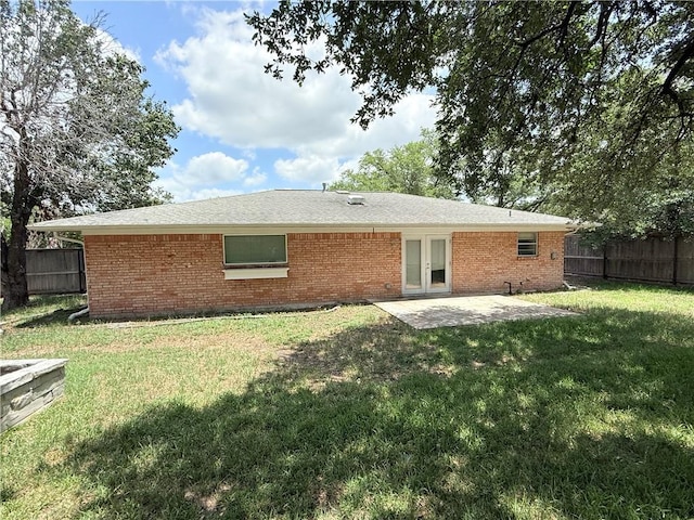 1223 Boswell St, College Station, TX 77840 - back of house featuring a fenced backyard, brick siding, a patio area, and french doors