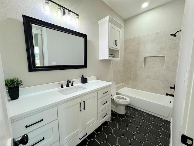 full bathroom with tile patterned floors, vanity, toilet, and tiled shower / bath combo