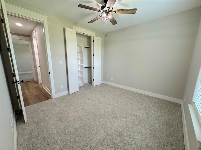 unfurnished bedroom with ceiling fan and carpet