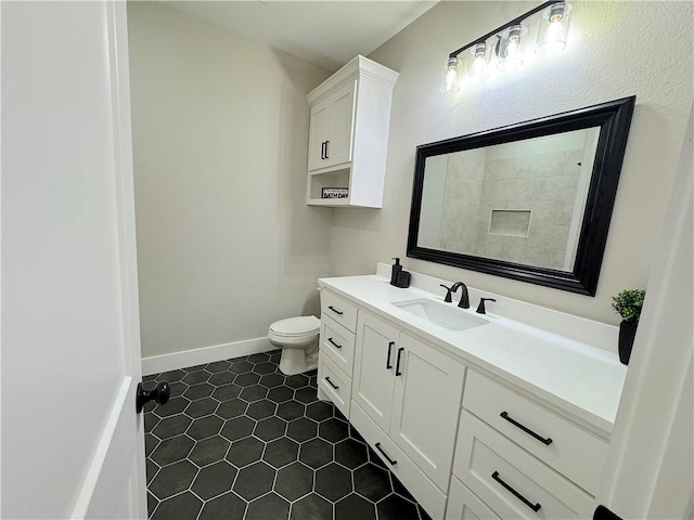 bathroom featuring tile patterned flooring, vanity, and toilet