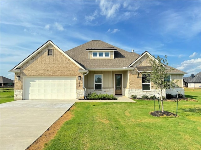 craftsman inspired home featuring a garage and a front lawn