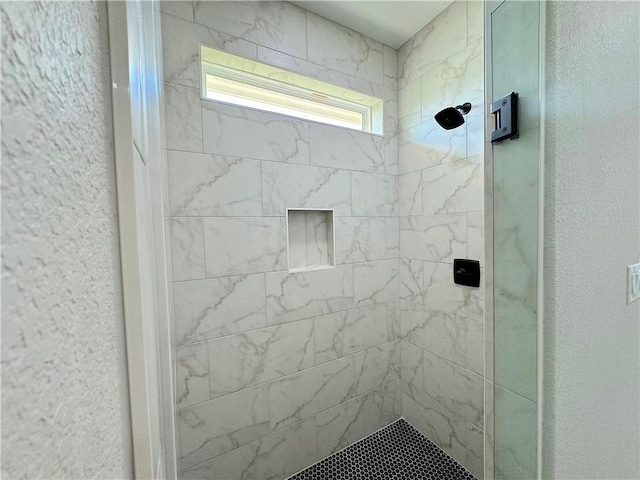 bathroom featuring a tile shower