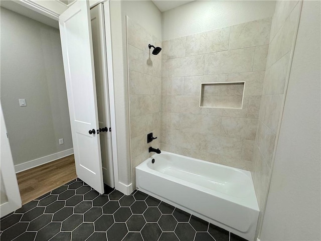 bathroom with wood-type flooring and tiled shower / bath combo