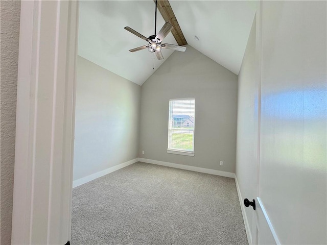 empty room with vaulted ceiling with beams, ceiling fan, and carpet floors