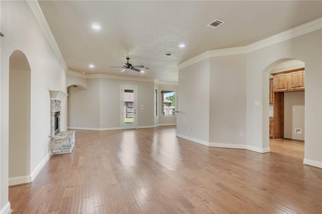 15613 Wood Brook Ln, College Station, TX 77845 - unfurnished living room featuring arched walkways, ceiling fan, recessed lighting, light wood-style flooring, and ornamental molding